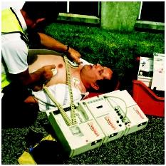 A portable defibrillator is used in an attempt to revive a man who had a heart attack before he is transported to an emergency room. (Photograph by Adam Hart-Davis. Science Source/Photo Researchers. Reproduced by permission.)