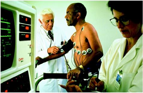 Doctors monitor a patient's vital signs during a stress test. (Photograph by Mug Shots. The Stock Market. Reproduced by  permission.)